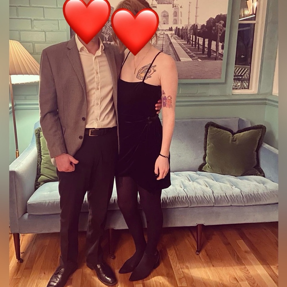 Black crushed velvet mini dress with spaghetti straps and waist tie.